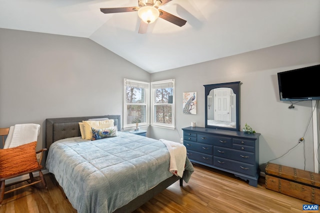 bedroom featuring ceiling fan, light hardwood / wood-style flooring, and vaulted ceiling