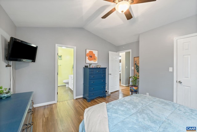 bedroom with ceiling fan, vaulted ceiling, connected bathroom, and light hardwood / wood-style floors