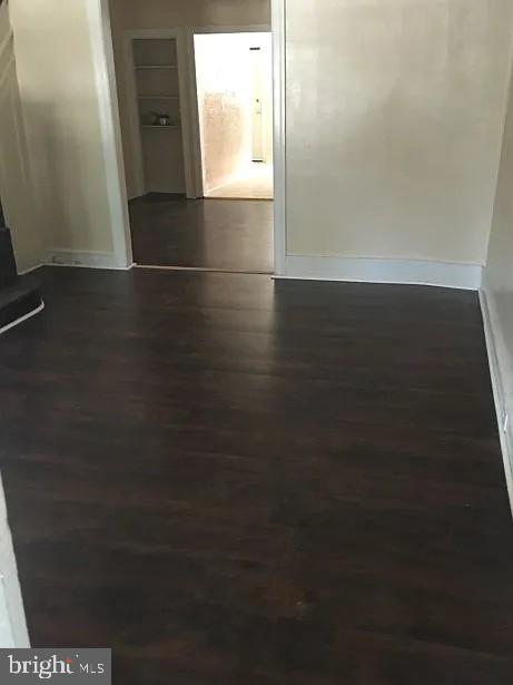 empty room featuring dark hardwood / wood-style flooring