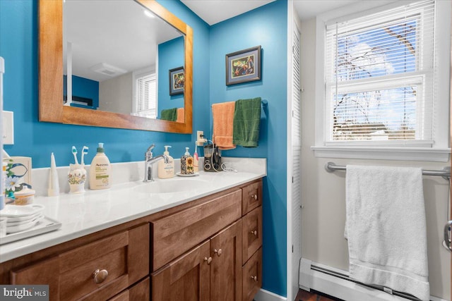 bathroom with vanity and baseboard heating