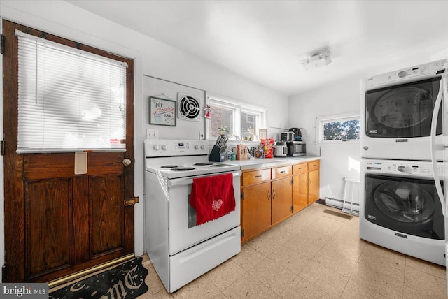 kitchen featuring stacked washer / dryer and electric range