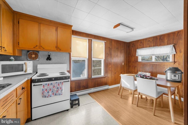 kitchen featuring a baseboard radiator and white appliances