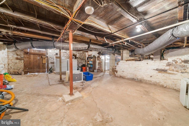 basement with washer and clothes dryer