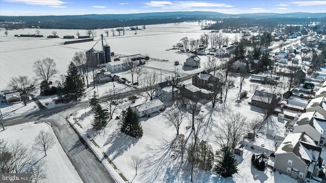 snowy aerial view with a mountain view