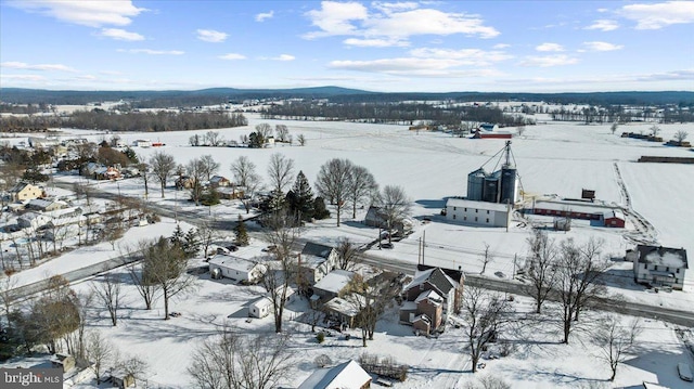 snowy aerial view featuring a mountain view