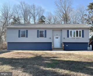 raised ranch with a front lawn