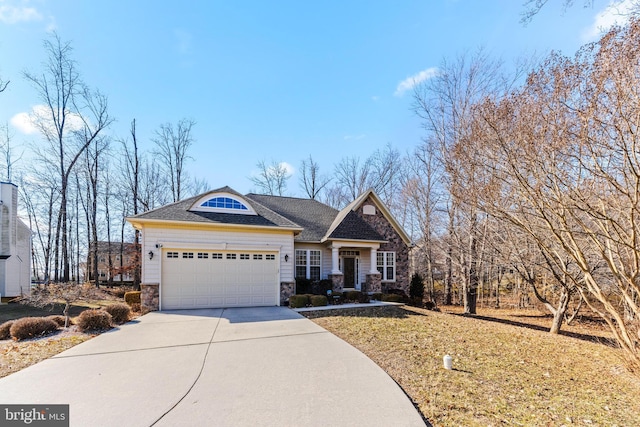 view of front facade with a shingled roof, stone siding, an attached garage, and concrete driveway