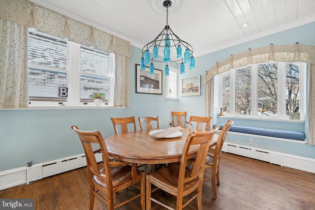 dining room featuring dark wood-type flooring, ornamental molding, and baseboard heating