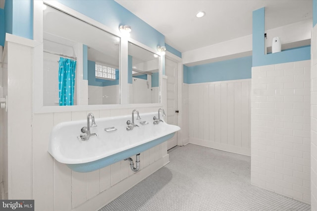 bathroom featuring tile patterned flooring, sink, and curtained shower