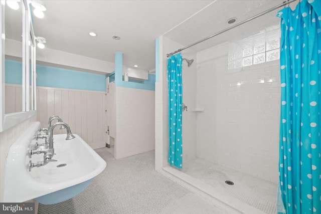 bathroom featuring tile patterned floors, curtained shower, and sink