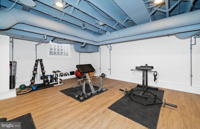 exercise room with wood-type flooring