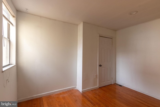 unfurnished room with light hardwood / wood-style flooring and a healthy amount of sunlight