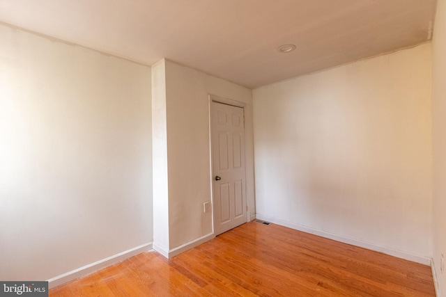 empty room with light hardwood / wood-style flooring