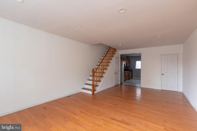 unfurnished living room with light wood-type flooring