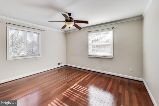 empty room with dark wood-type flooring, ornamental molding, and ceiling fan