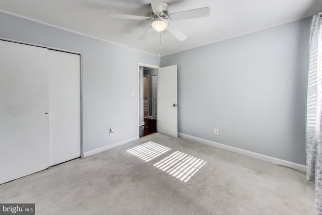 unfurnished bedroom with light carpet, a closet, and ceiling fan