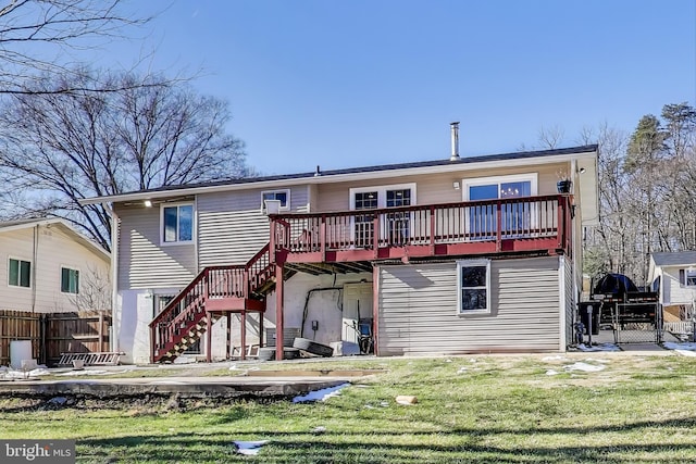 rear view of house with a yard and a deck