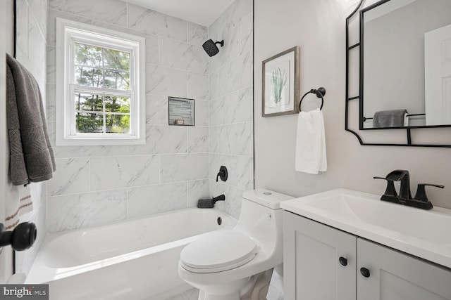 full bathroom with tiled shower / bath combo, vanity, and toilet