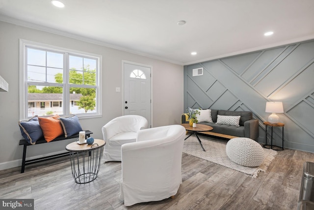 living room featuring crown molding and hardwood / wood-style flooring