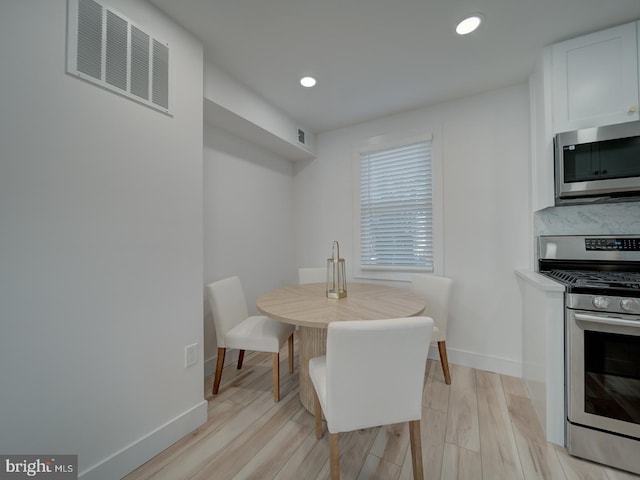 dining space with light wood-type flooring