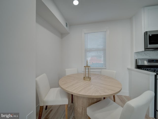 dining area with light hardwood / wood-style flooring