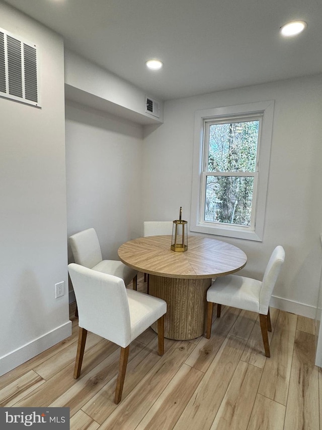 dining space with light hardwood / wood-style flooring