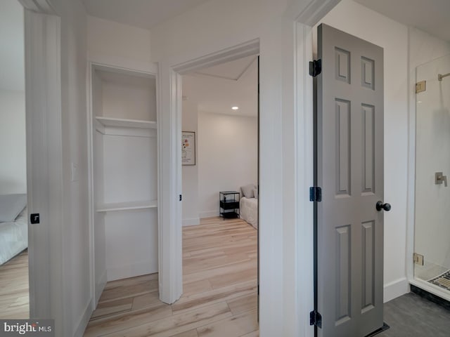 hallway with light hardwood / wood-style flooring