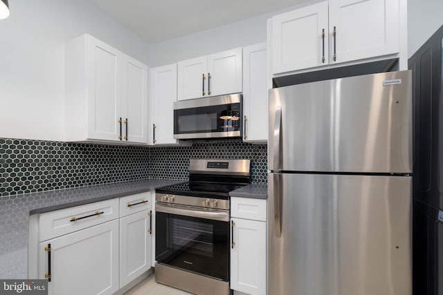 kitchen featuring white cabinetry, backsplash, and stainless steel appliances