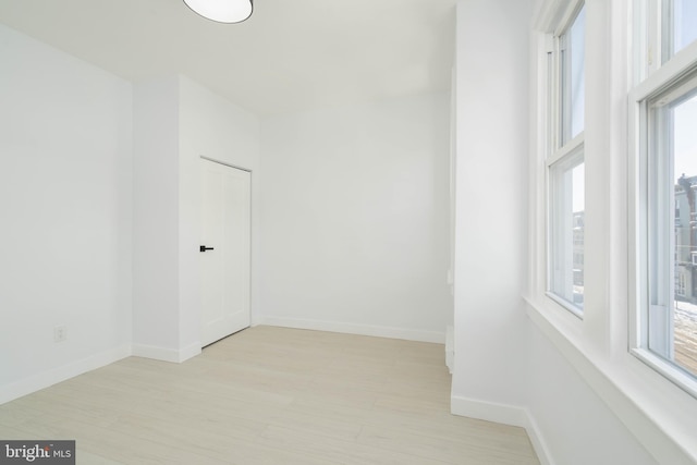 empty room featuring light hardwood / wood-style floors and a wealth of natural light