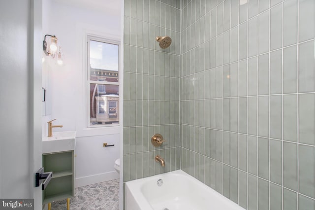 full bathroom featuring sink, toilet, and tiled shower / bath