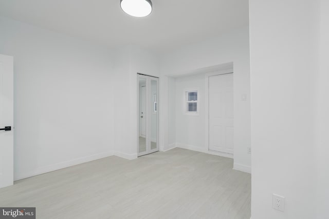 spare room with light hardwood / wood-style flooring