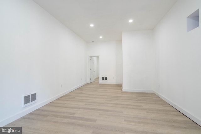 empty room with light hardwood / wood-style flooring