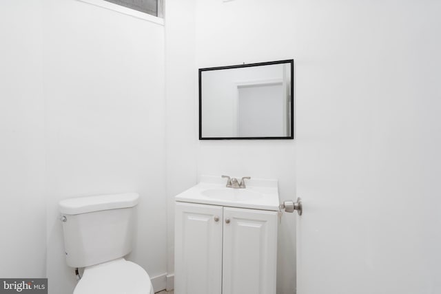 bathroom with toilet and vanity