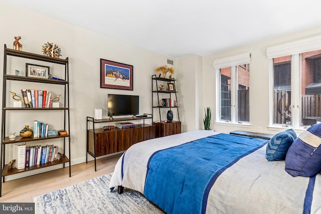 bedroom with hardwood / wood-style flooring