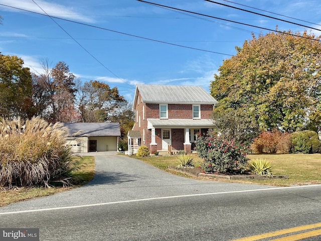 view of front of house with covered porch and a front yard