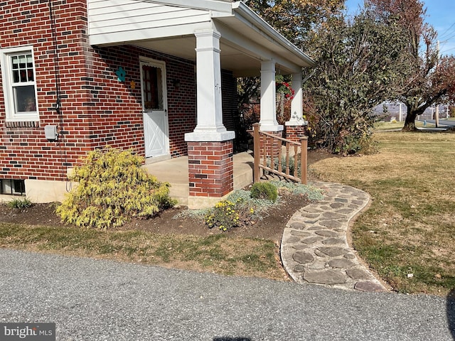 view of side of property with a lawn and a porch