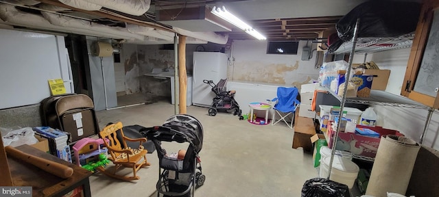 basement with white refrigerator