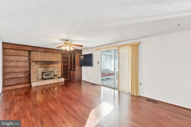 unfurnished living room with wood-type flooring, built in features, and a textured ceiling