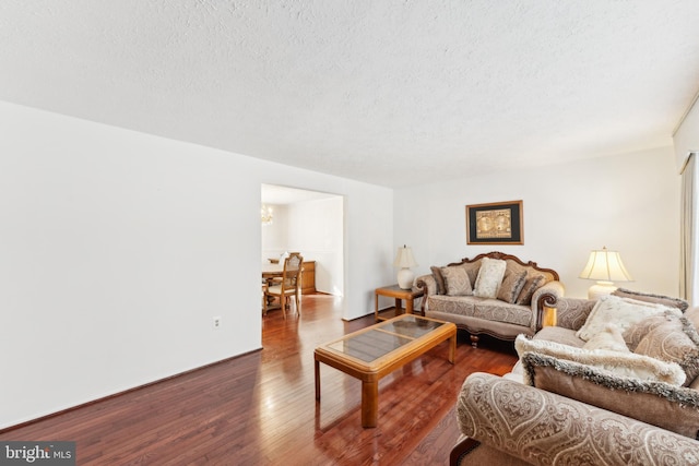 living room featuring hardwood / wood-style flooring and a textured ceiling