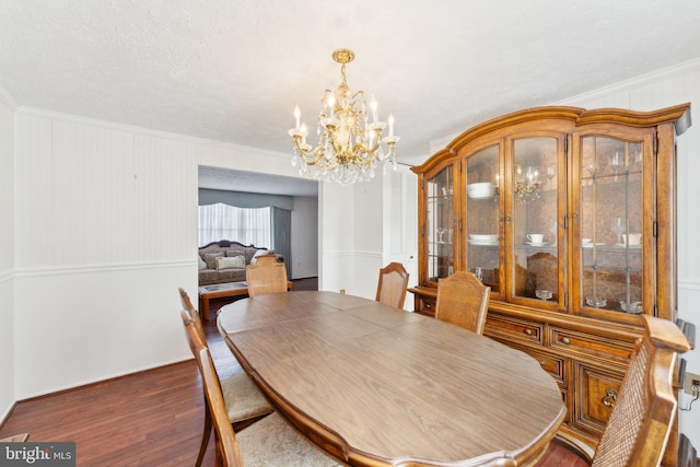 dining area with crown molding, a chandelier, and dark hardwood / wood-style floors