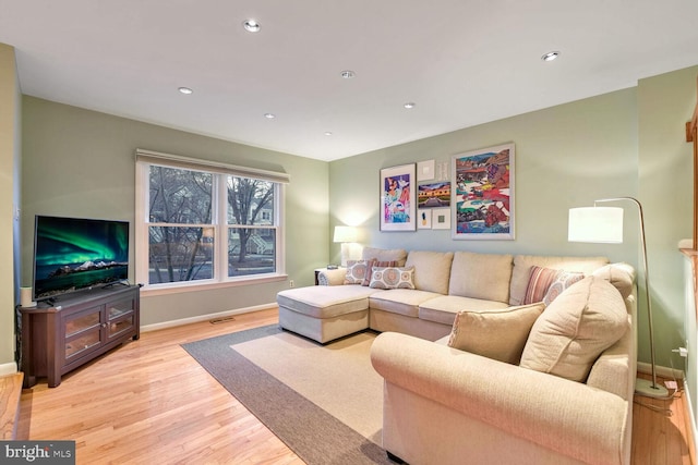 living room with light hardwood / wood-style flooring