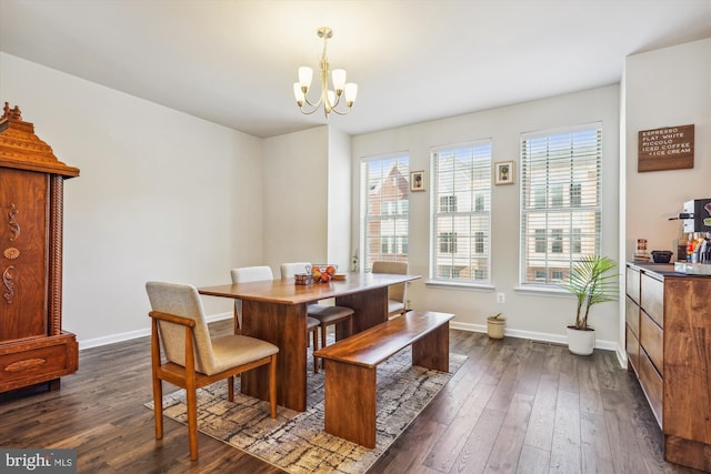 dining area featuring dark hardwood / wood-style floors and a notable chandelier