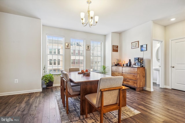 dining area featuring dark hardwood / wood-style floors and a chandelier