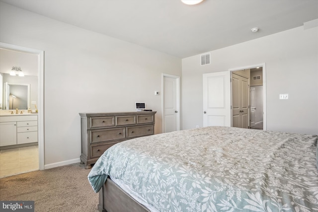 carpeted bedroom featuring ensuite bathroom