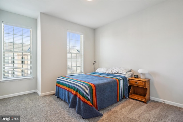 carpeted bedroom featuring multiple windows