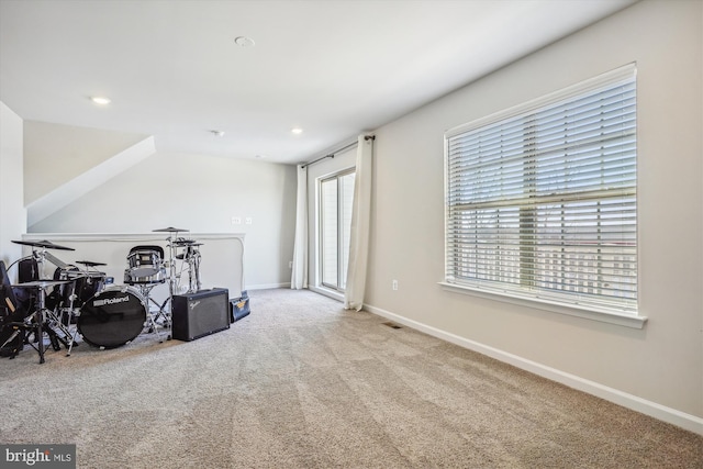 additional living space featuring light colored carpet