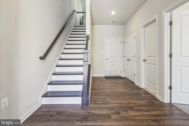 stairway with hardwood / wood-style flooring