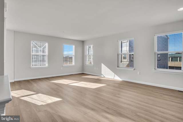 unfurnished room with light hardwood / wood-style flooring