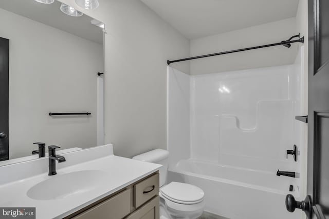 full bathroom featuring washtub / shower combination, toilet, and vanity