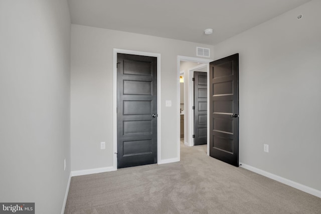 unfurnished bedroom featuring light colored carpet